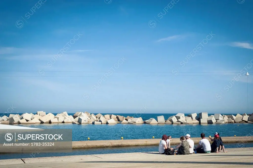 Spain, Parc Del Forum; Barcelona, Festival Goers Relaxing Next To The Sea At Primavera Sound Music Festival
