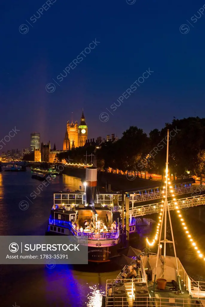 Boats On Thames River Illuminated At Night, London,England,Uk