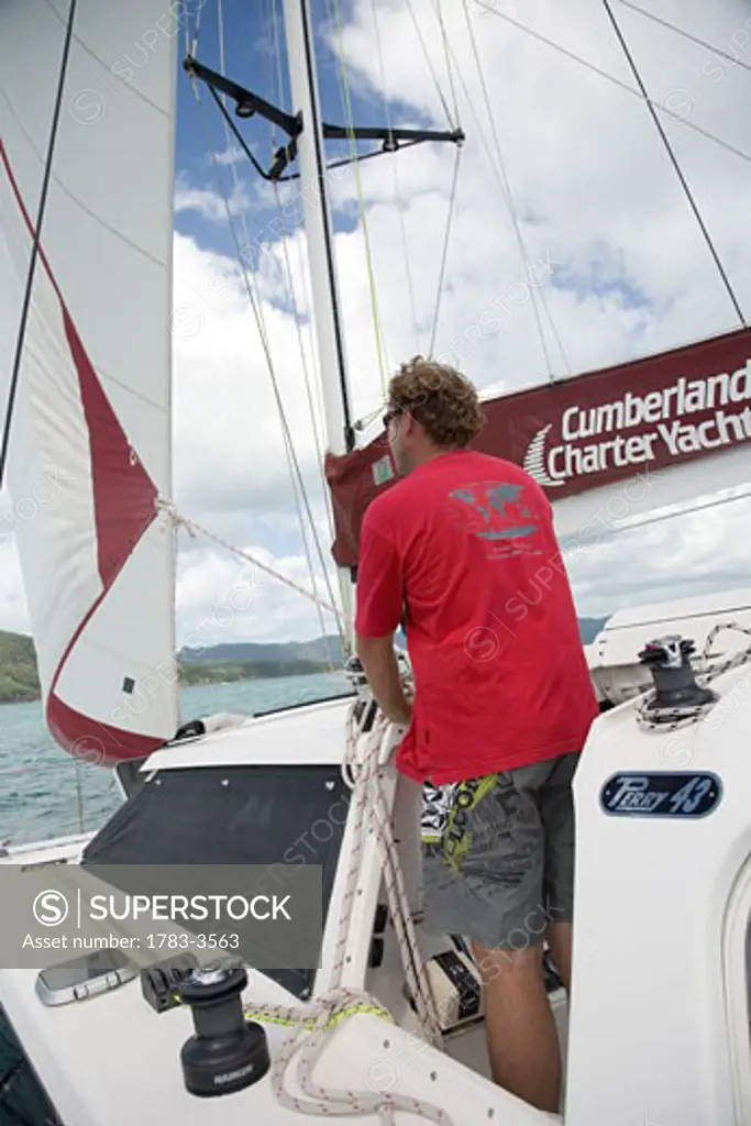 Man sailing in the Whitsunday Islands, Queensland, Australia