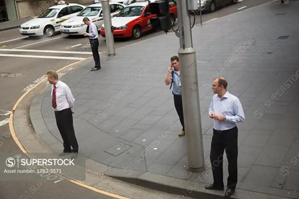Business men on sidewalk in street, Sydney, New South Wales, Australia