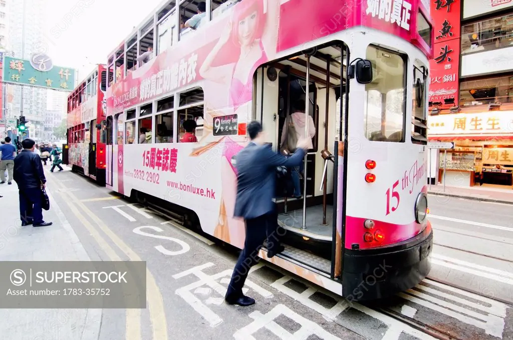 China, Hong Kong, Man Boarding On Cable Car; Wanchai