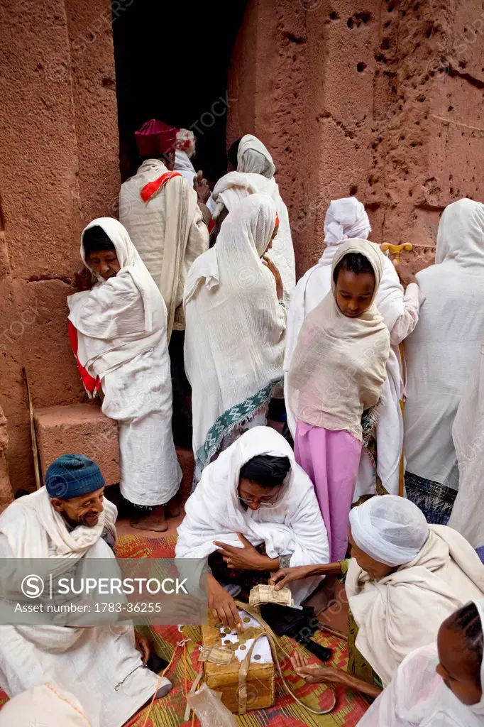 Ethiopia, Ethiopian Orthodox Pilgrims Making Money Offerings In The Courtyard Of ABet Emmanuel Rock Church; Lalibela