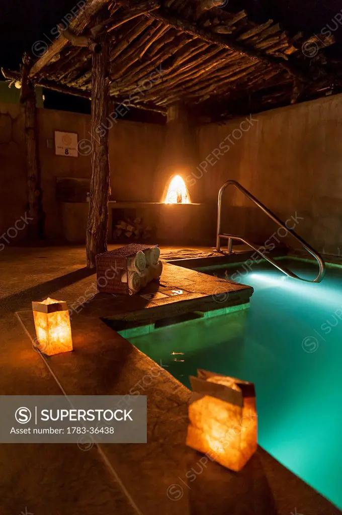 Outdoor Spa Pool At Night With A Kiva Fire In Ojo Caliente Mineral Springs Is A Northern New Mexico Resort And Spa Near Santa Fe