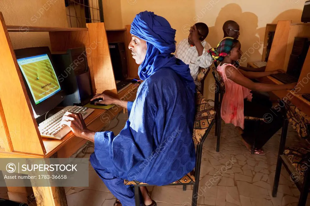 Niger, Sahara Desert, Agadez Region, Tuareg Man Surfing Net At Internet Cafe; Agadez