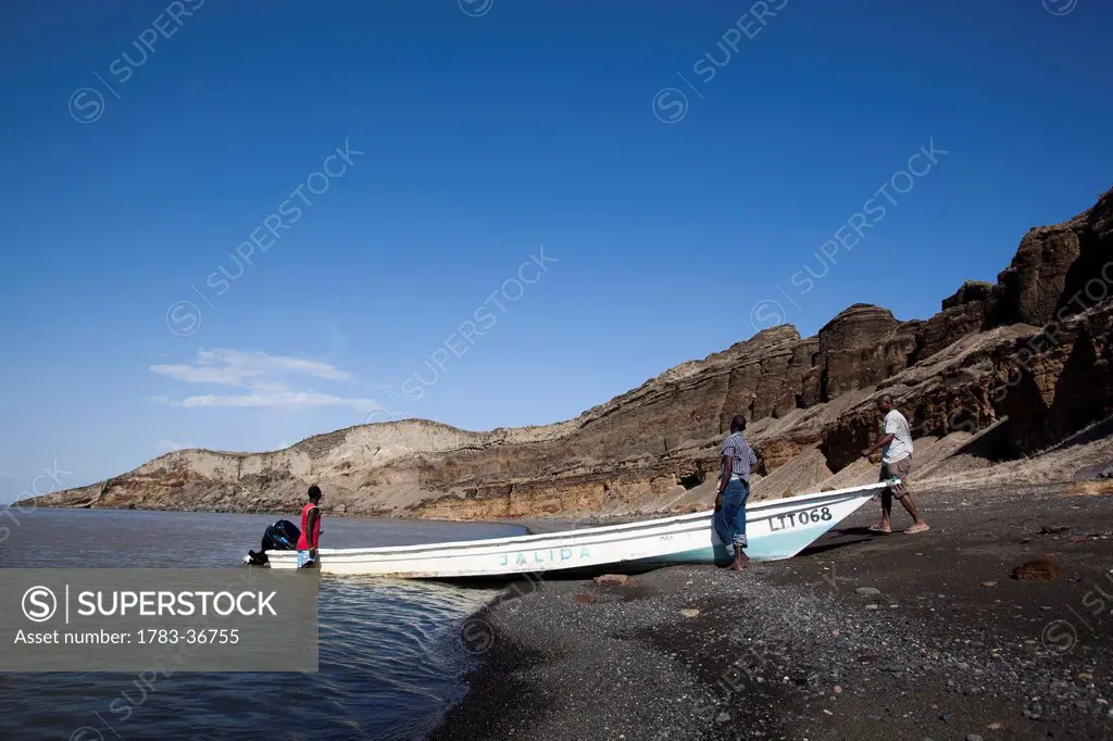 Kenya, Turkana, View of men and fishing boat in Central Island National Park; Turkana Lake