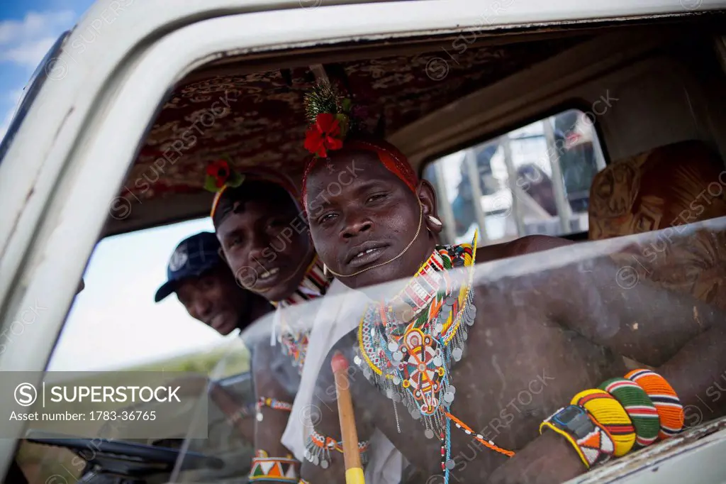 near Maralal; Kenya, View of young Samburu warriors (Moran) in lorry cab