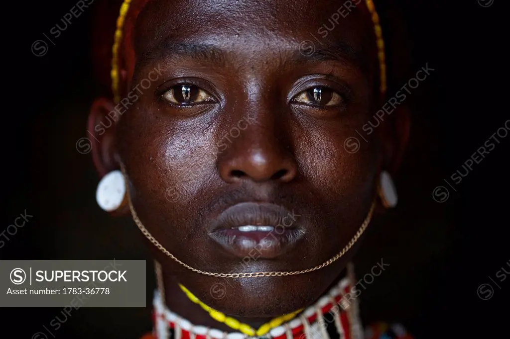 Kenya, Portrait of young Samburu man in traditional dress; South Horr