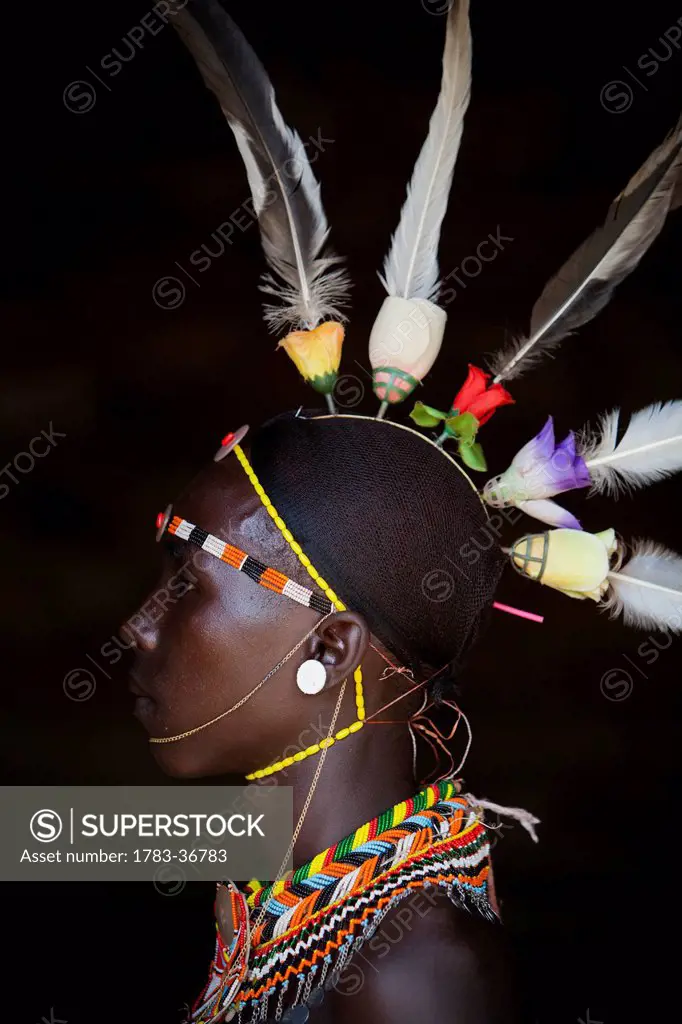 Kenya, Portrait of young Samburu man in traditional dress; South Horr