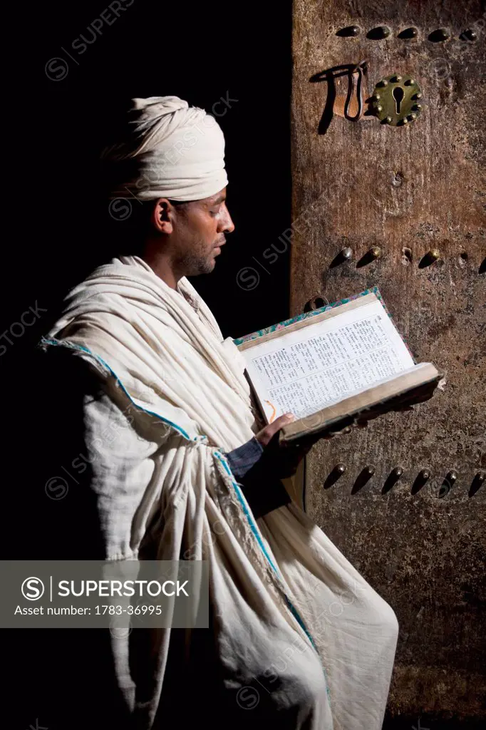 Northen Ethiopia, Ethiopian Orthodox Priest Reading Bible; Lalibela