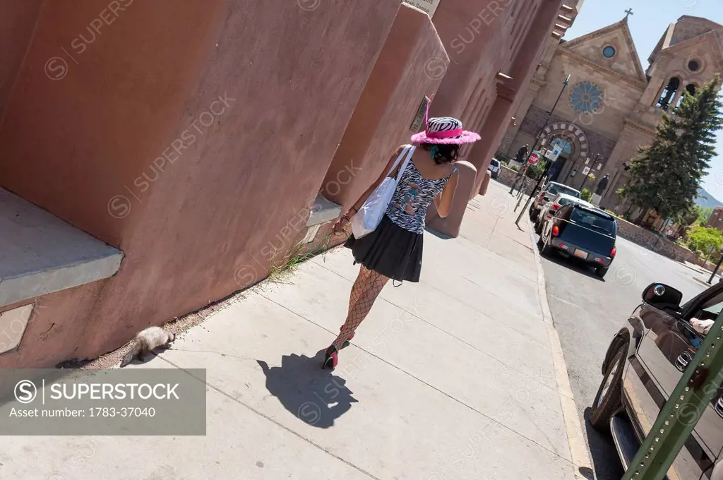 Young Fashionable Woman Walking With Her Ferret By The St Francis Cathedral, Santa Fe, New Mexico, Usa