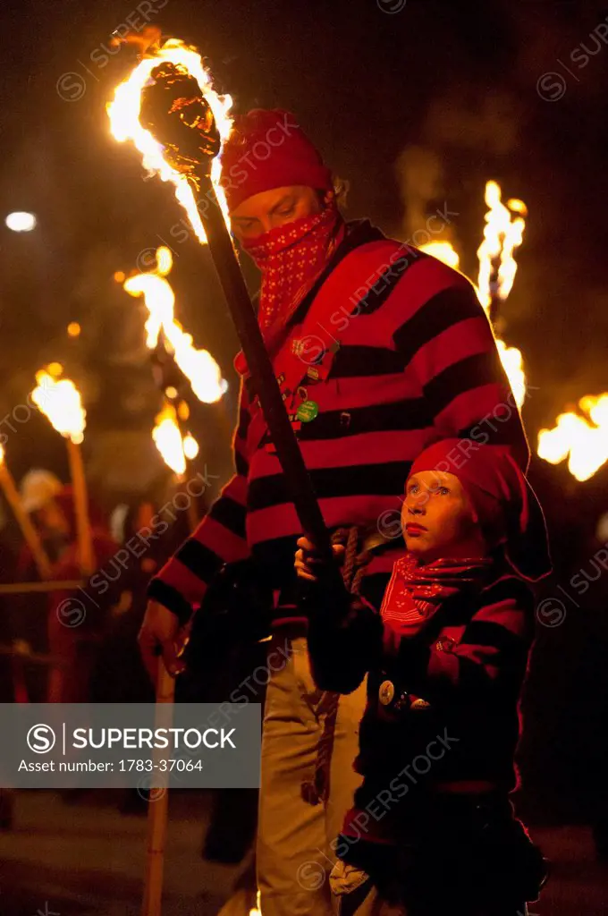 Young Boy Dressed As A Smuggler With Burning Torch On The United Grand Procession, Bonfire Night, Lewes, East Sussex, Uk