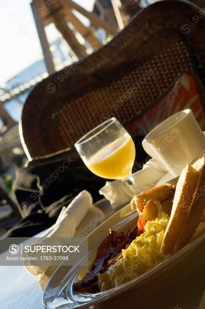 Typical American breakfast of scrambled eggs, bacon, fingerling potatoes, toast, orange juice and coffee; Islamorada, Florida Keys, Florida , USA