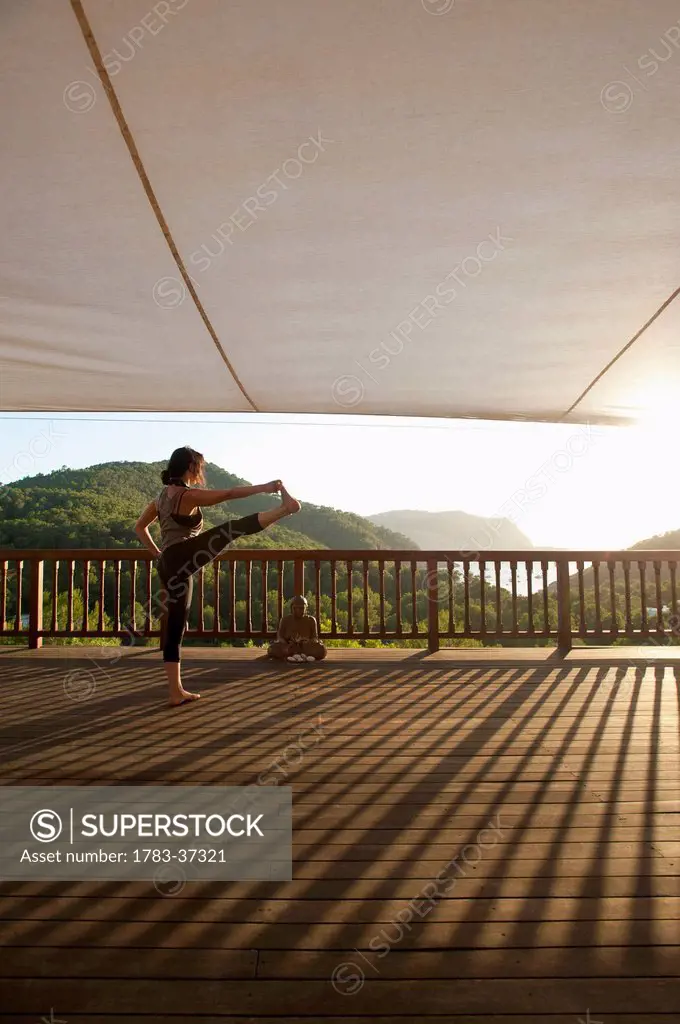Lady doing yoga at Ibiza Yoga; Benirras, Ibiza, Spain