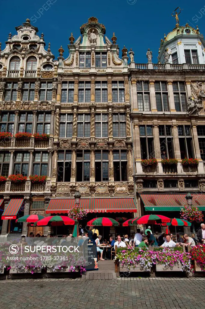 People eating and drinking in outside cafes in Grand Place; Brussels, Belgium