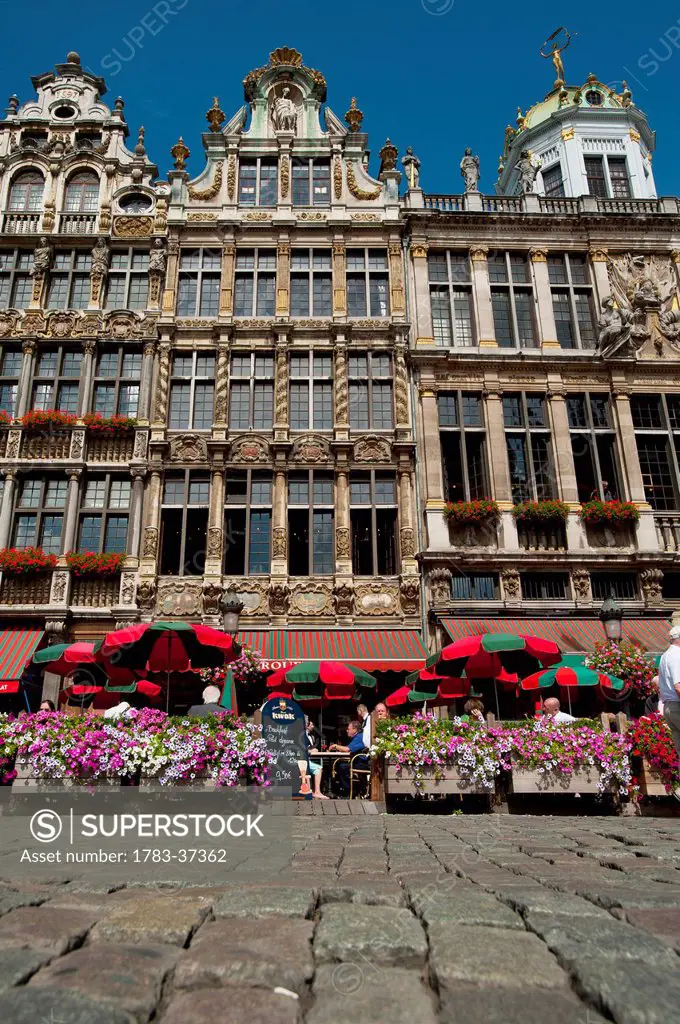 People eating and drinking in outside cafes in Grand Place; Brussels, Belgium