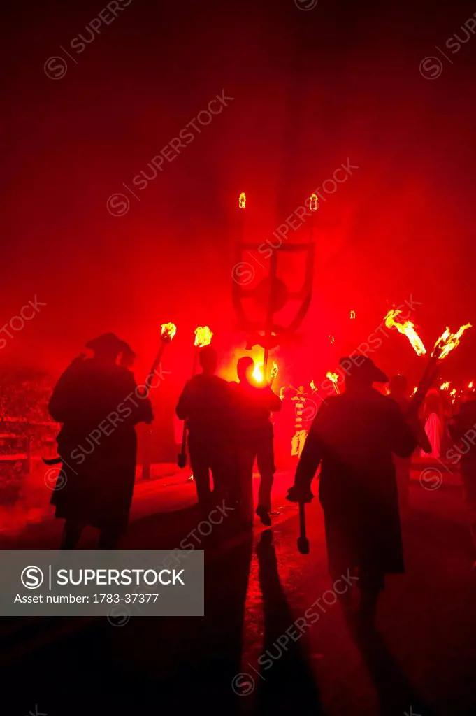 People dressed as pirates and smugglers from Southover Bonfire Society walking in procession of Nevill Junior Bonfire Night; Lewes, East Sussex, Engla...