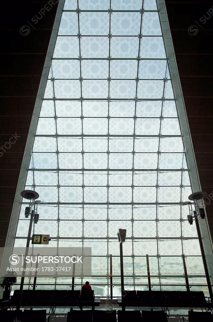 Silhouette of man waiting in terminal of Dubai International Airport; Dubai, United Arab Emirates