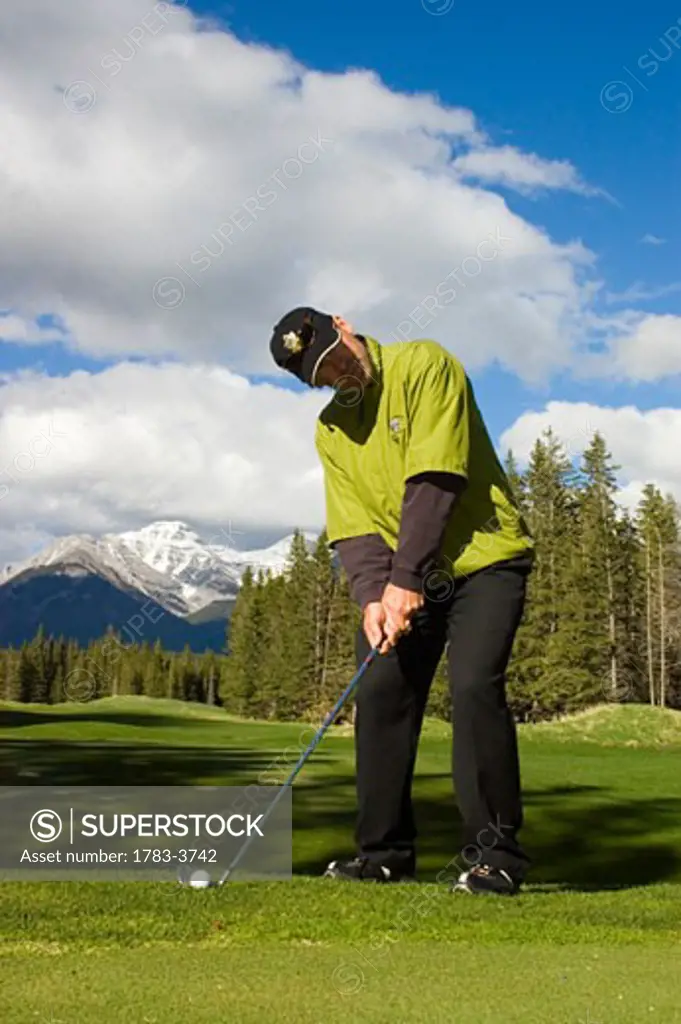 A man playing golf at Banff Springs Hotel Golf Course , Banff National Park Alberta Canada