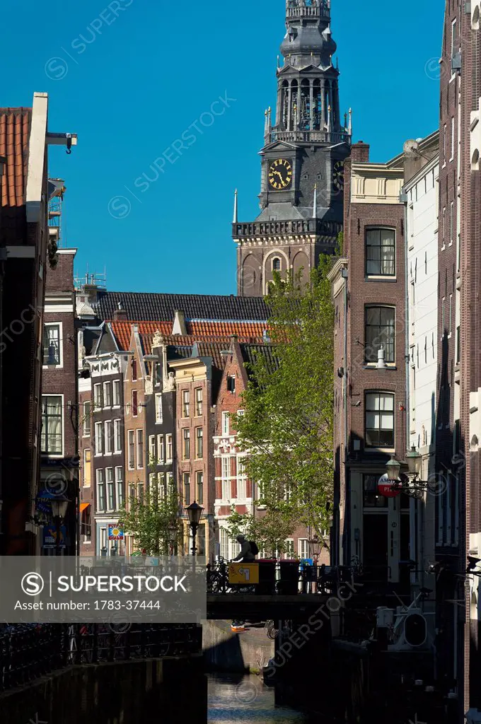 Looking along canal to Oude Kerk Church; Amsterdam, Holland