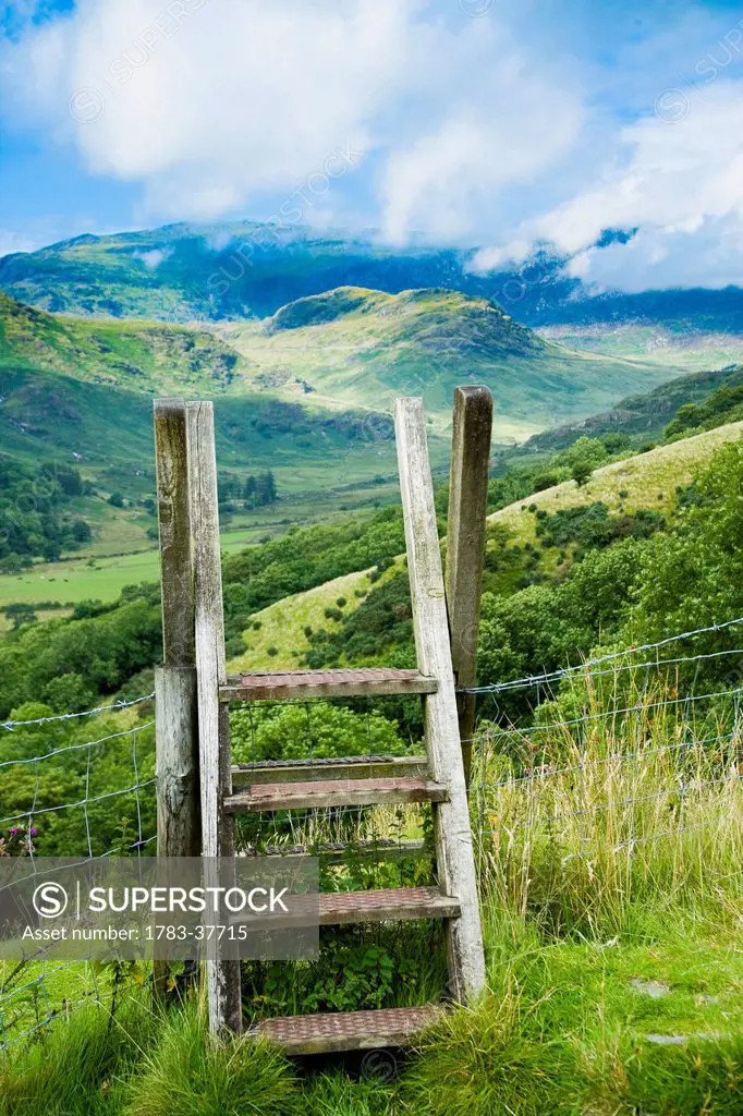 Stile over fence, on country trail; Nantgwynant, Snowdonia National Park, North Wales, UK