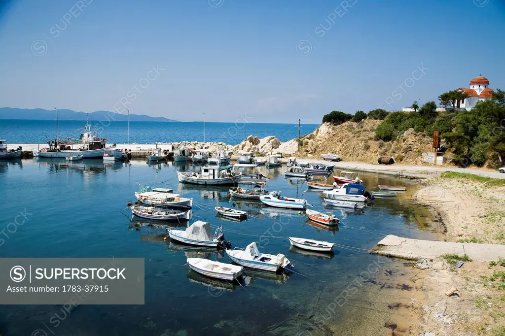 Small traditional fishing boats moored in harbour; Nea Roda, Halkidiki, Greece