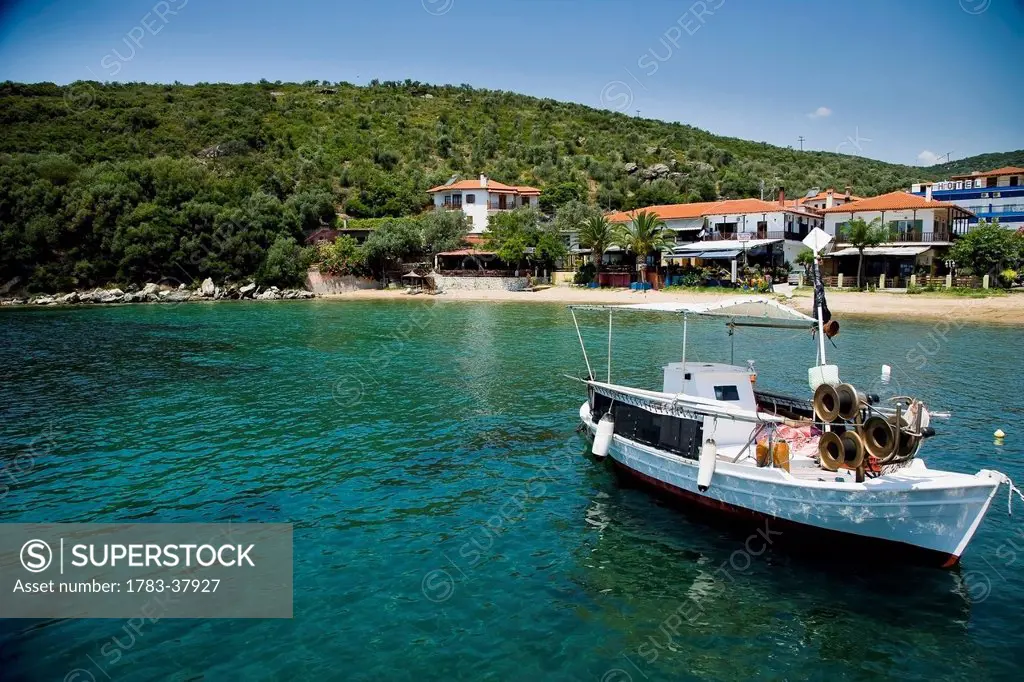 Traditional wooden fishing boat moored in small harbour; Pirgadikia, Halkidiki, Greece