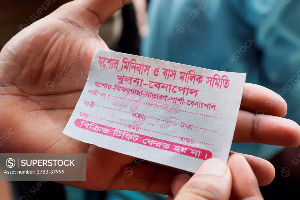 Passenger holding bus ticket; Bangladesh