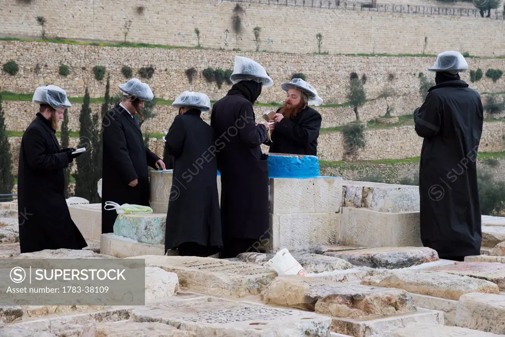 Group of orthodox Jews praying at tomb of Ohr Hachaim at Mount of Olives cemetery; Jerusalem, Israel