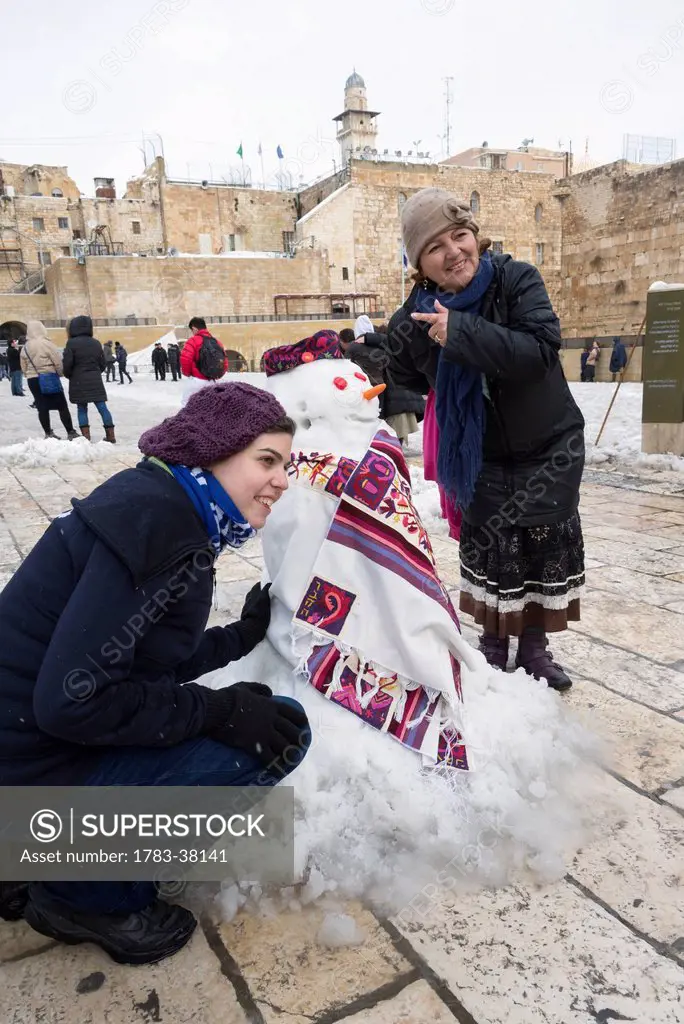 Girl and woman posing with snowman, January 10, 2013, Western Wall; Jerusalem, Israel