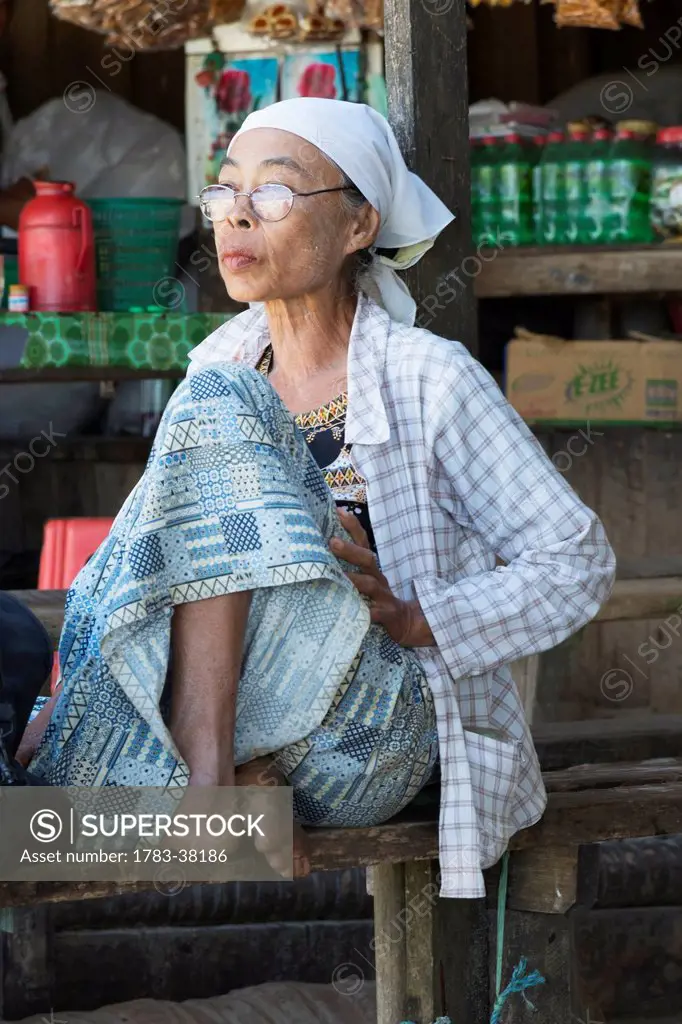 Portrait of an elderly woman waiting for public transport; Irrawaddyi Division, Myanmar