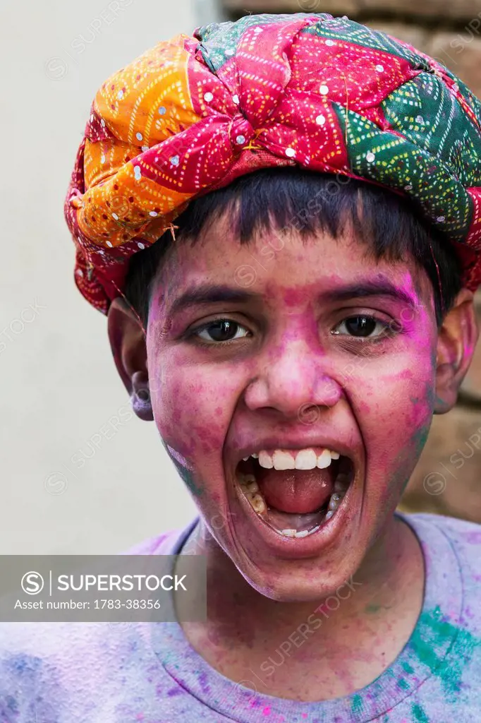 Portrait of Indian Hindu boy celebrating Lathmar Holi; Barsana, Uttar Pradesh, India