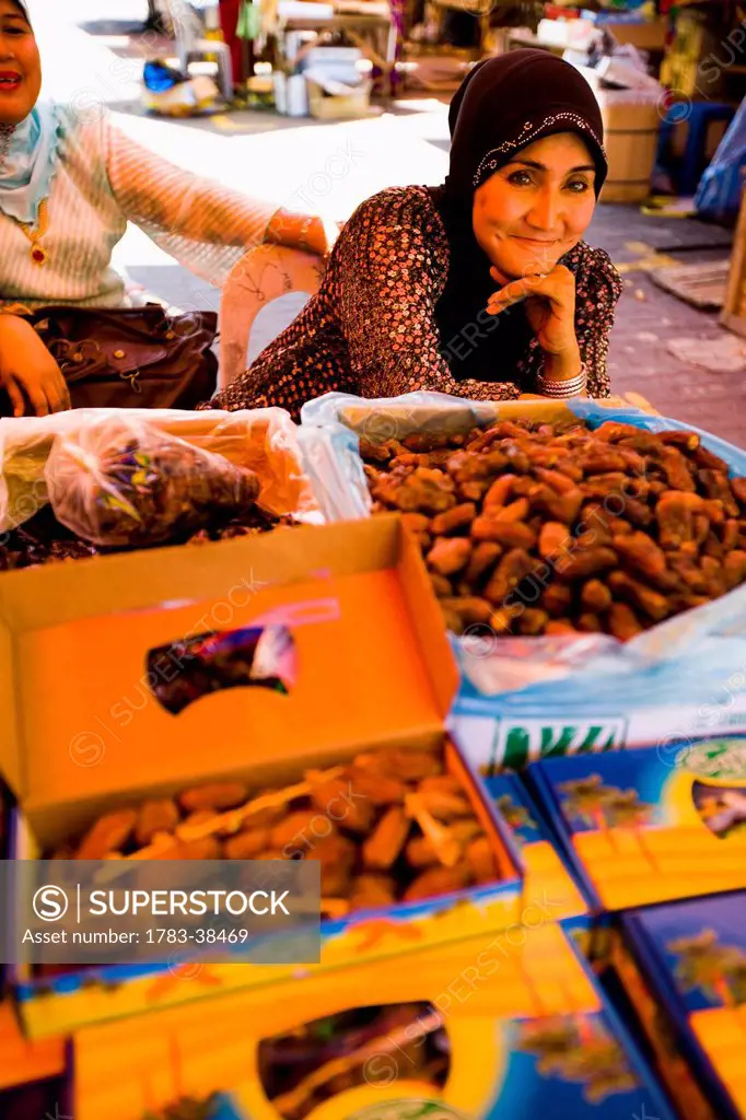 Female stall keepers selling dates at large indoor and outdoor market; Pasar Payang central market, Kuala Terengganu, Terengganu, Malaysia