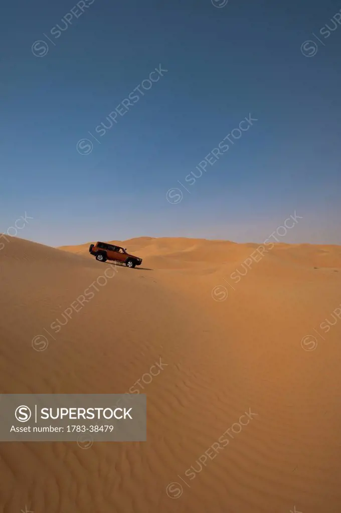 Four wheel drive going across sand dunes; Liwa, Abu Dhabi, UAE