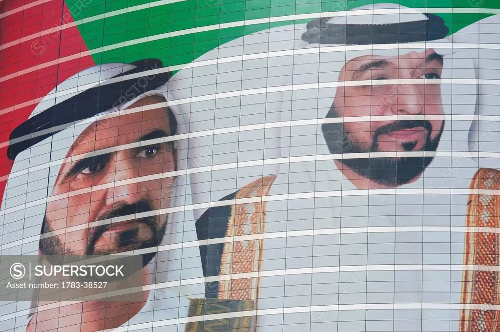 Large portrait of Sheikh Mohammed Bin Rashid Al Maktoum and Khalifa bin Zayed Al Nahyan on building; Dubai, UAE