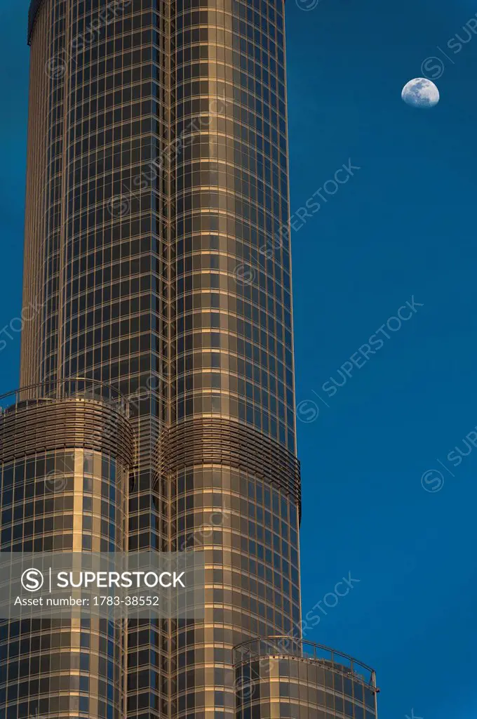 Detail of Burj Khalifa with moon rising behind; Dubai, UAE