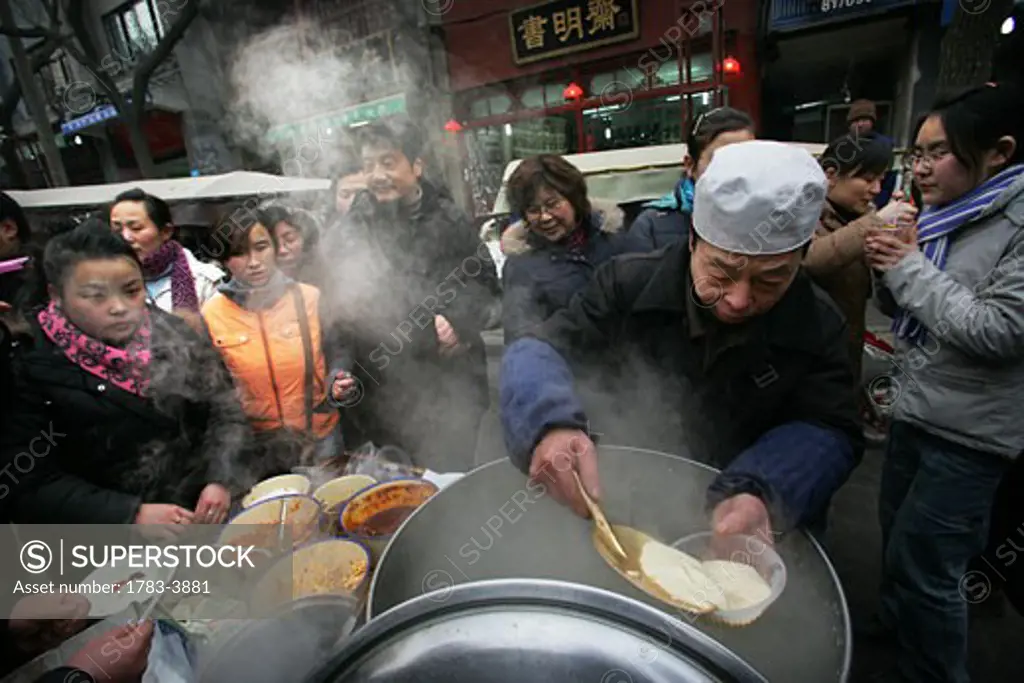 Street stall selling food in the Muslim Quarter, Xian, Xi'an, Capital of Shaanxi Province, China 