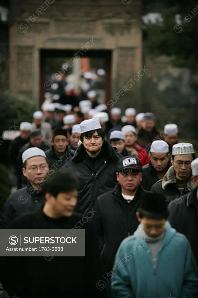 The Hui community, Chinese Muslims, arrive at a mosque for Friday Prayers , Xian Great Mosque, Xian, Xi'an, Capital of Shaanxi Province, China