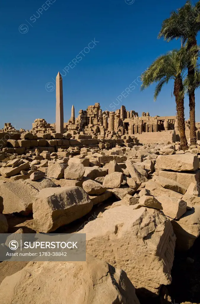 Looking across large area of assorted stones from ruins of Karnak Temple, Precinct of Amun; Luxor, Egypt
