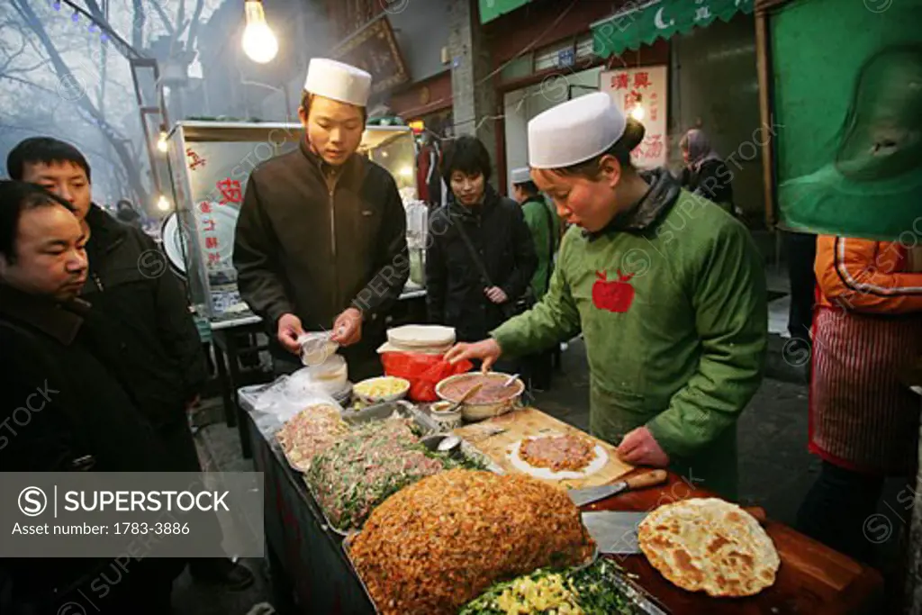 A street stall selling food in the Muslim Quarter, Xian, Xi'an, Capital of Shaanxi Province, China 