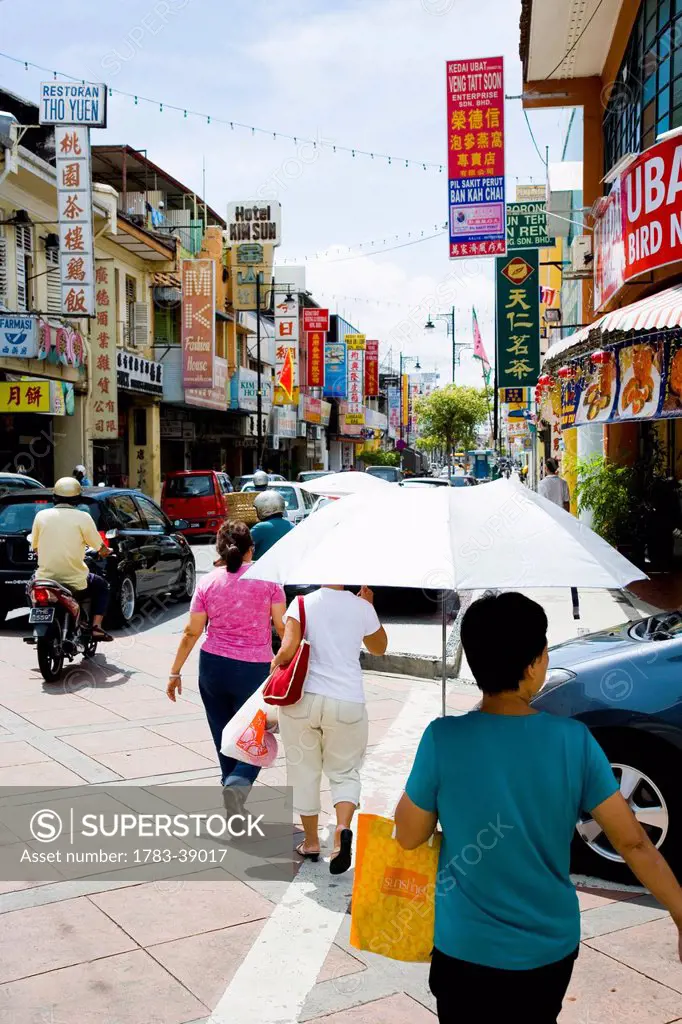 People walking down busy street; Georgetown, Pulau Pinang (Penang), Malaysia