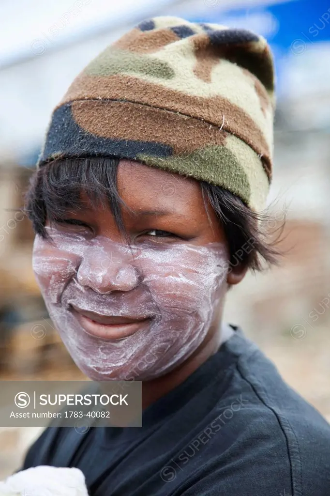 South Africa, Garden Route, Port Elizabeth, Portrait of woman wearing hat and face painting; New Brighton
