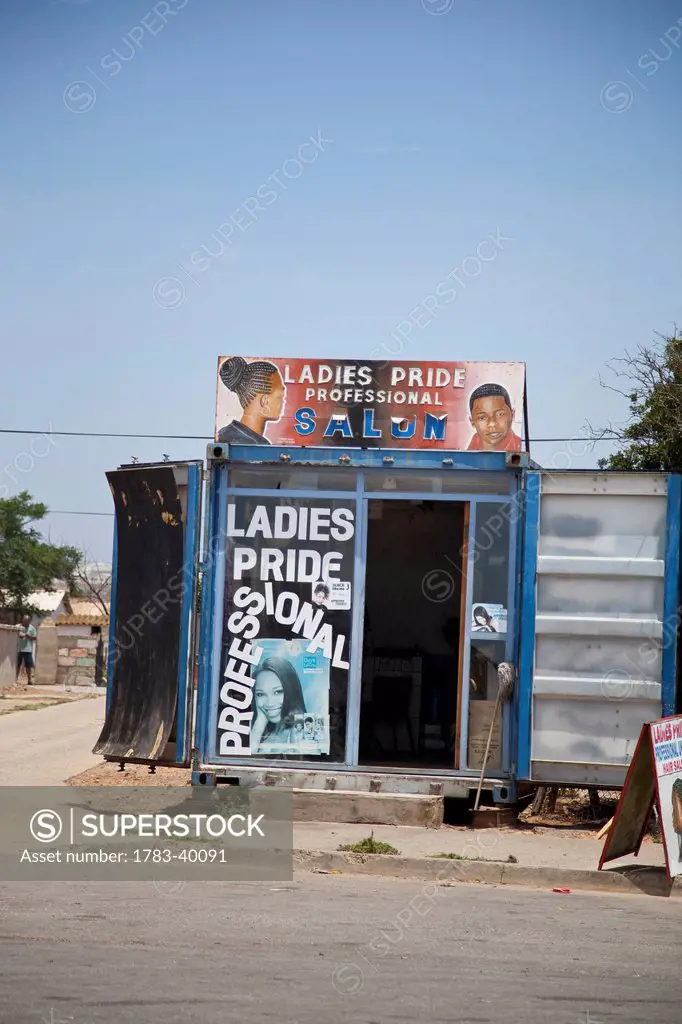 South Africa, Garden Route, Port Elizabeth, Ladies hairdresser kiosk with ads; New Brighton