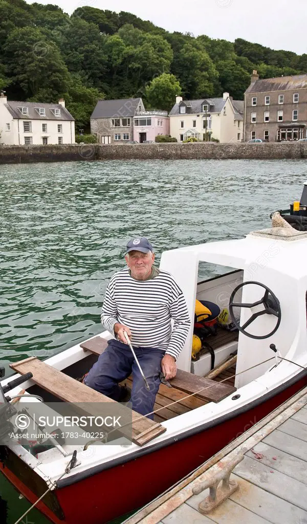 United Kingdom, Wales, Pembrokeshire, Fisherman in his boat; Dale