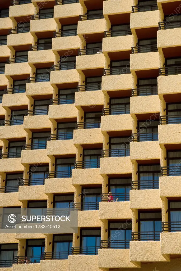 Woman On Balcony Of Hotel, Torremolinos, Andalucia, Spain.