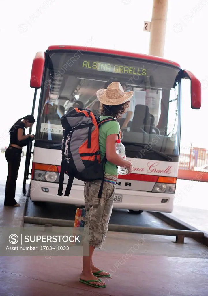 Backpacker waiting for bus; Spain