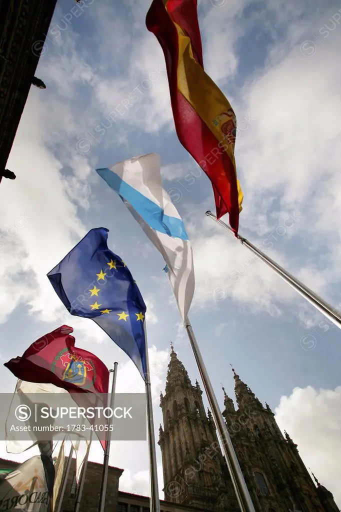 Spain, Galicia, Flags flying in front of cathedral; Santiago de Compostela