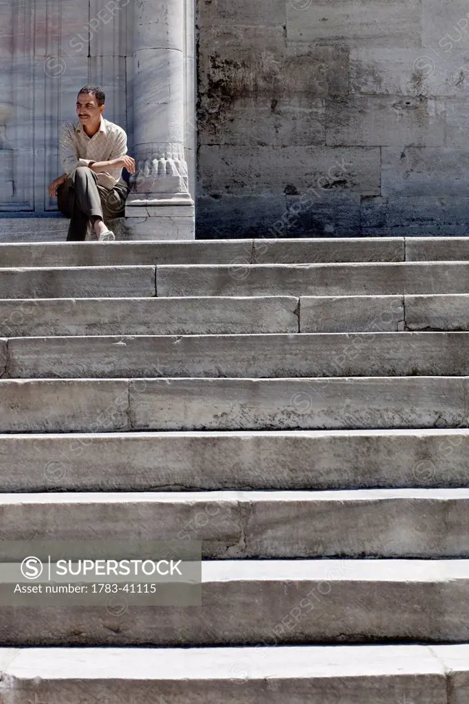Turkey, Istanbul, Man sitting by Blue Mosque; Sultanahmet