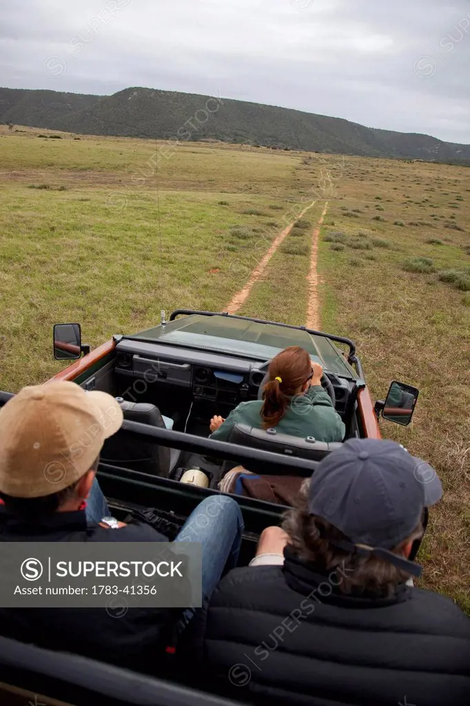 South Africa, Garden Route, Tourists on game drive taking photos; Kariega Game Reserve