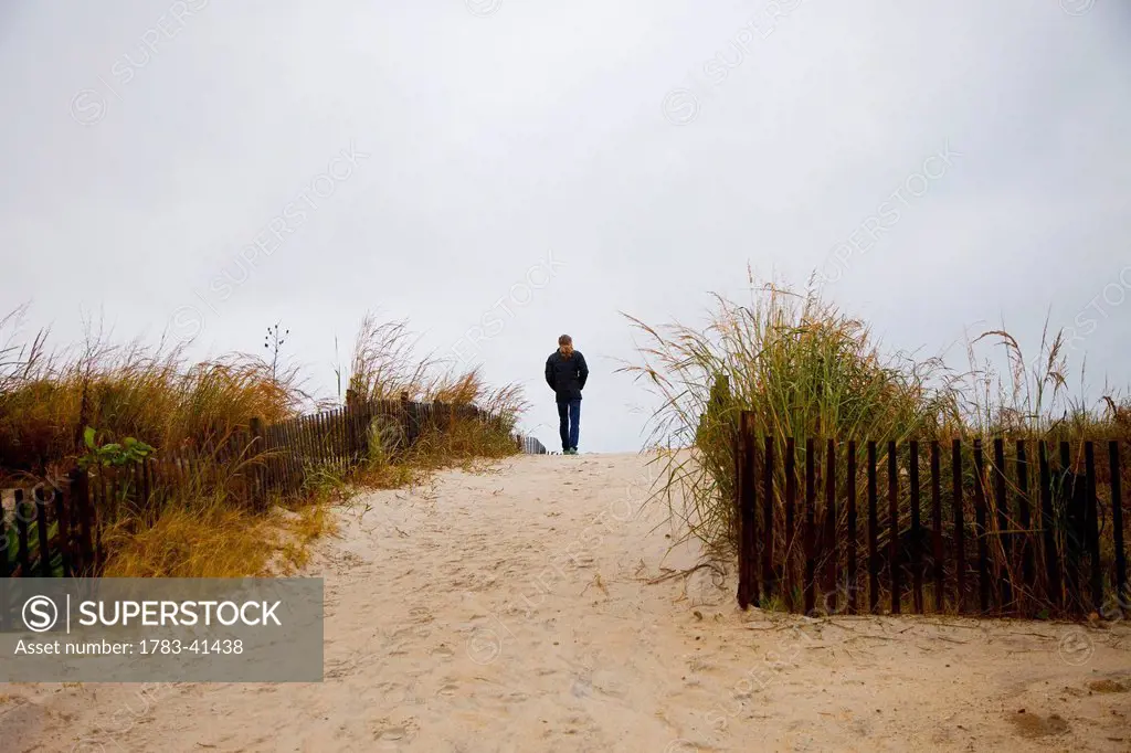 USA, Maryland, Lonely walker on sandy beach; Ocean City
