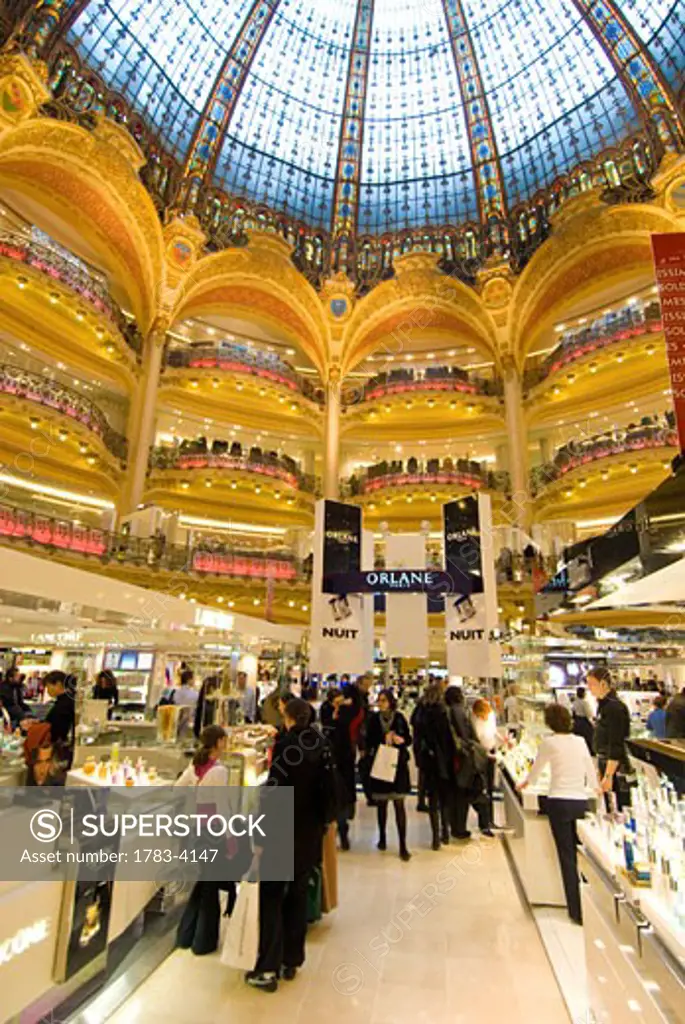 Shoppers under the domed central area of Galeries Lafayette, Paris, France 